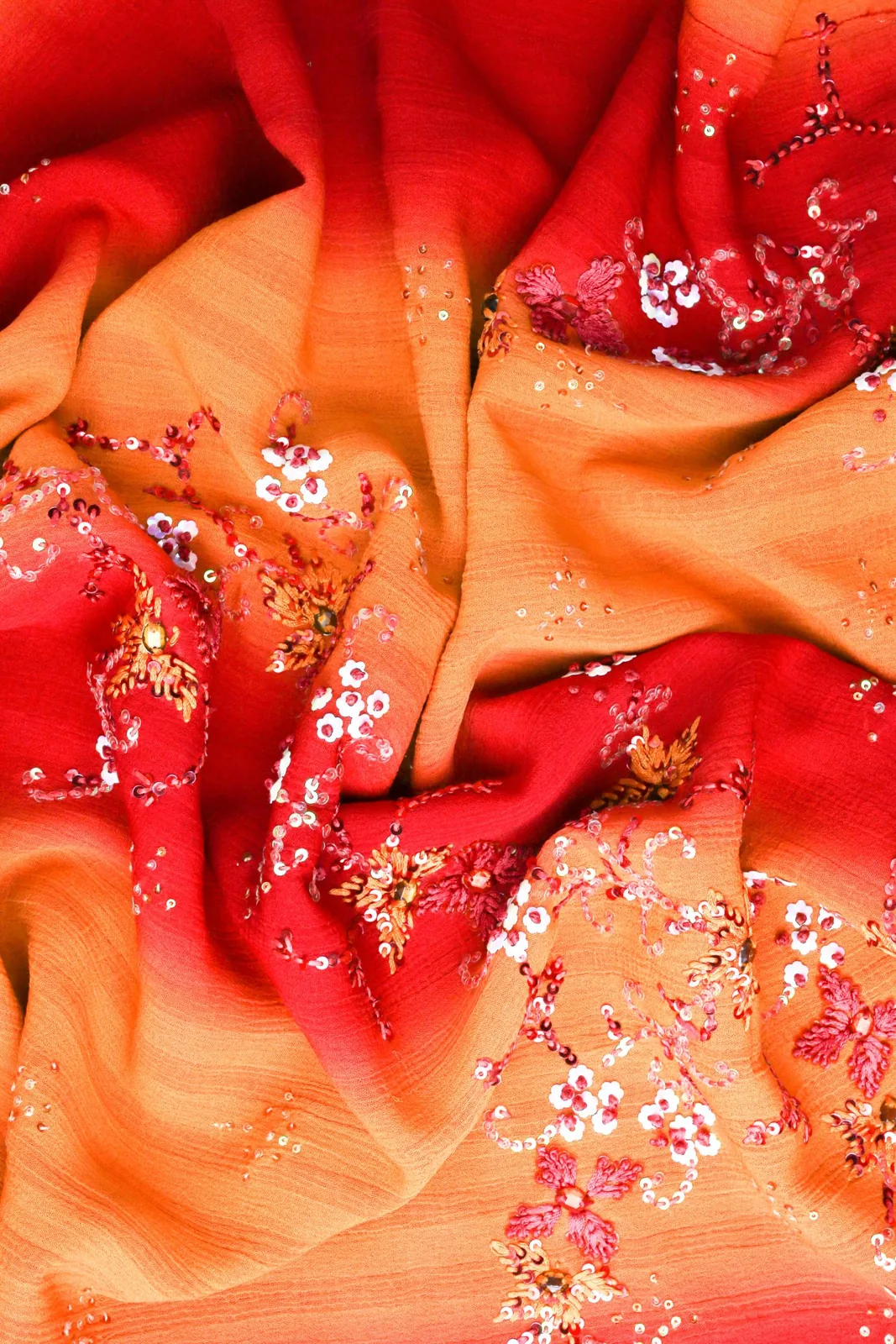 Sequins and floral embroidery on warm orange fabric